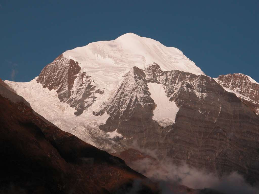 Manaslu 06 09 Lapuchun From Syala As the sun set, the clouds obscuring Lapuchun (5960m) cleared to reveal a beautifully white summit with huge shoulders left and right.